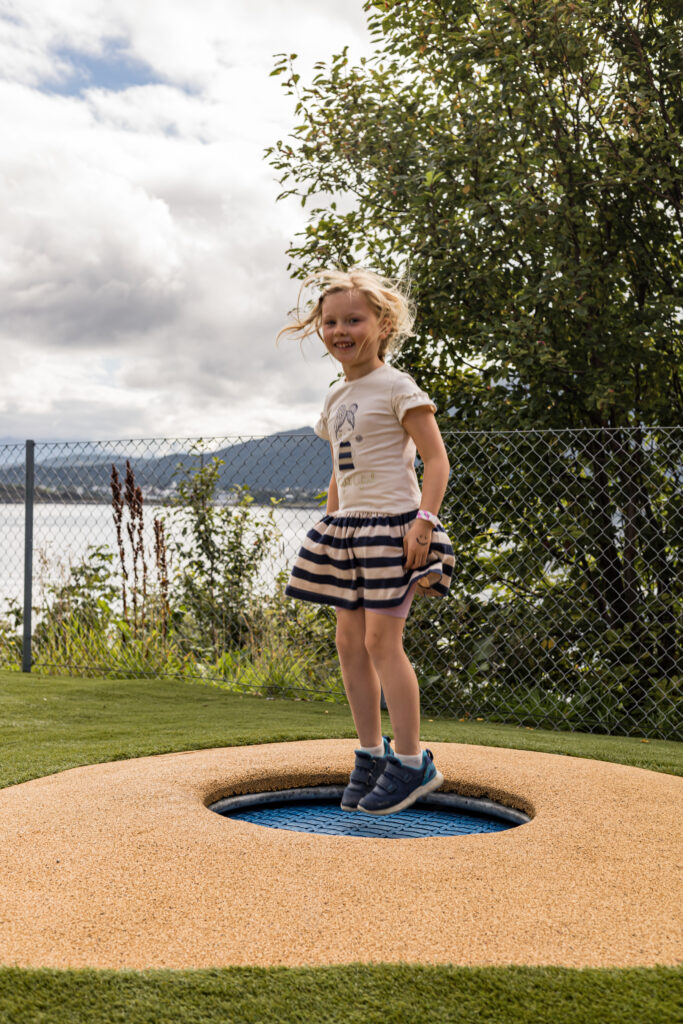 Jente som hopper på trampoline i barnehage